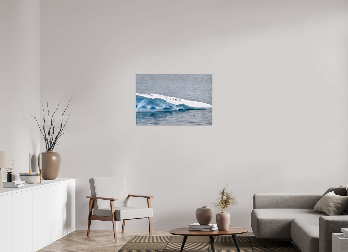 Antarctic Penguin Procession 36×24″ gallery-quality color ALDibond metal print by Richard H Knight, displayed in a modern living room with white credenza, modern chair, coffee table on a rug and cloth sofa