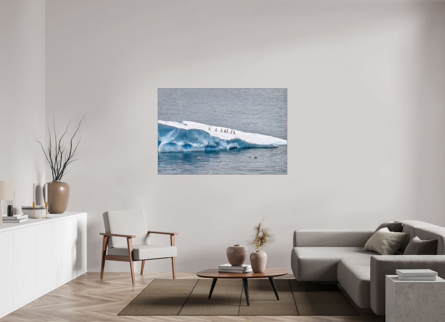 Antarctic Penguin Procession 60×40″ gallery-quality color ALDibond metal print by Richard H Knight, displayed in a modern living room with white credenza, modern chair, coffee table on a rug and cloth sofa